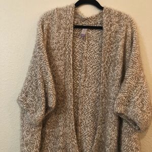 Fluffy beige/tan cardigan.